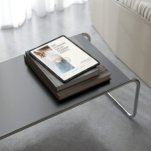 Ipad showing a legal pdf, on top of a coffee table and books.